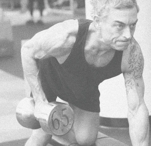 Member performing a heavy single-arm dumbbell row