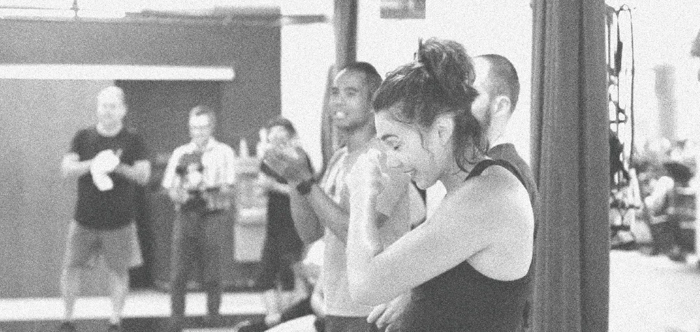 Members applauding a teammate at the end of a class