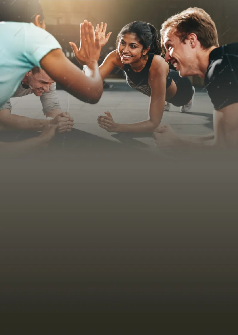 Members high-fiving each other while holding a plank at ZUM Fitness